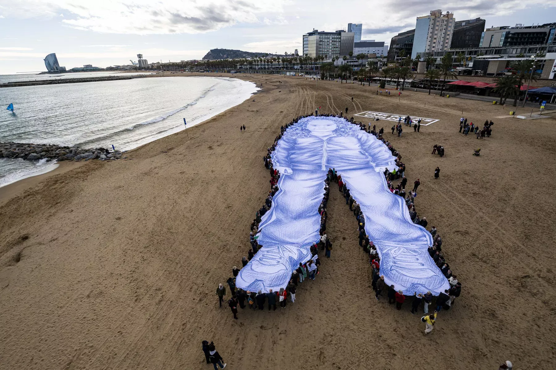 Protest în Barcelona în memoria fetiței palestiniene Hind Rajab. Portretul acesteia a fost ridicat pe o plajă